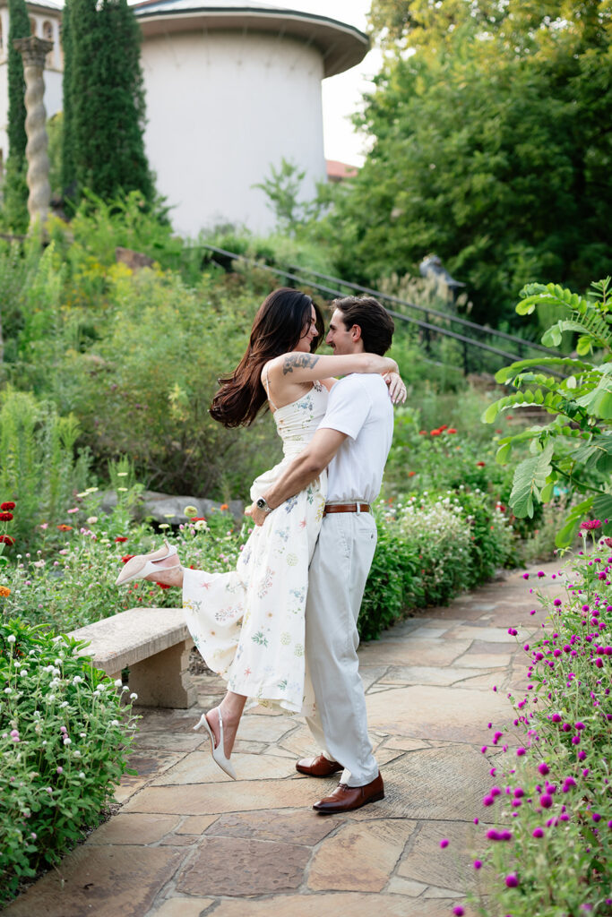 couple walking through the Philbrook gardens during engagement photos