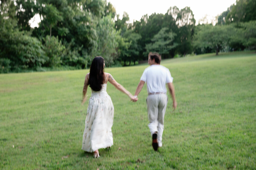 couple walking through the Philbrook gardens during engagement photos