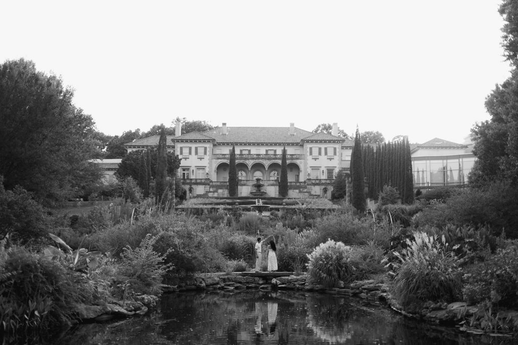 couple walking through the Philbrook gardens during engagement photos